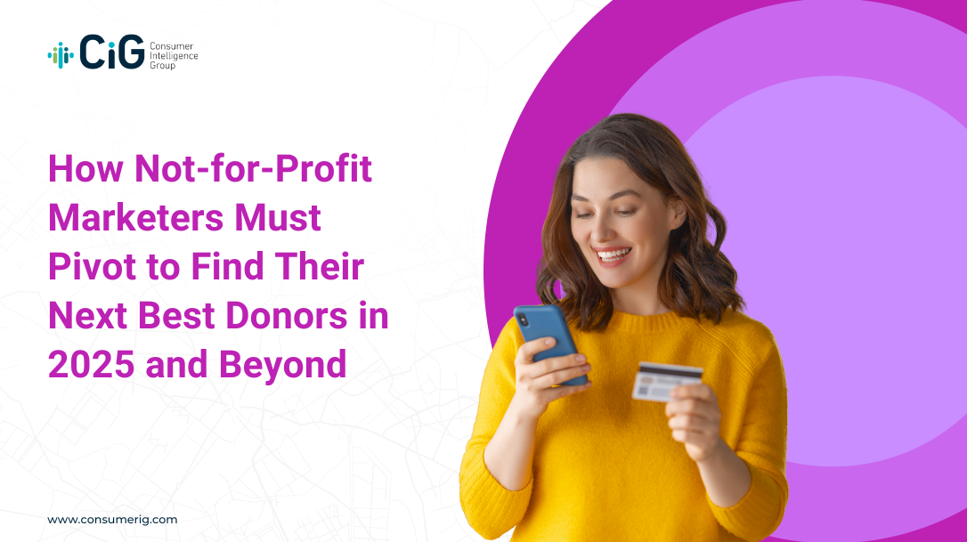 A smiling woman holding a phone and looking at a credit card in her other hand.