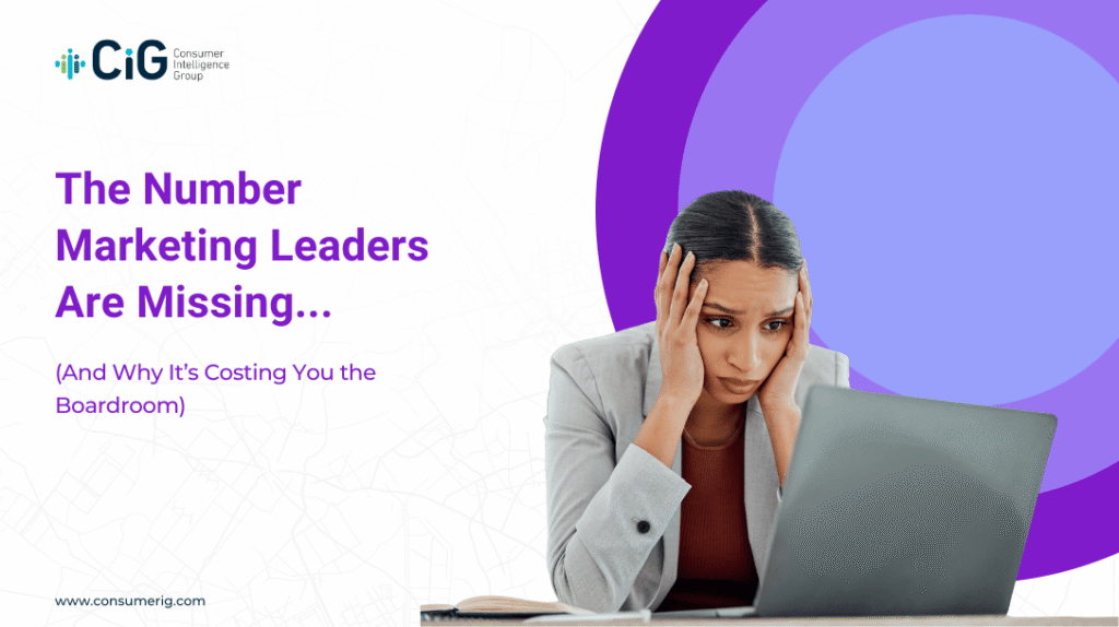 A stressed woman in a gray blazer looking at a laptop